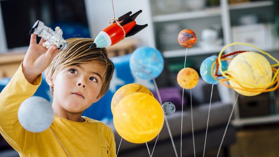 Boy playing with space toys