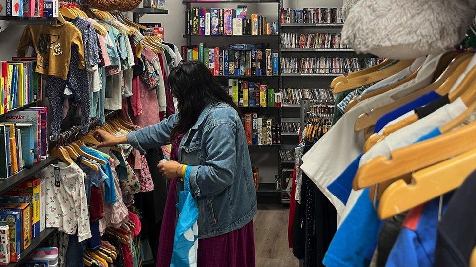 woman shopping in charity shop