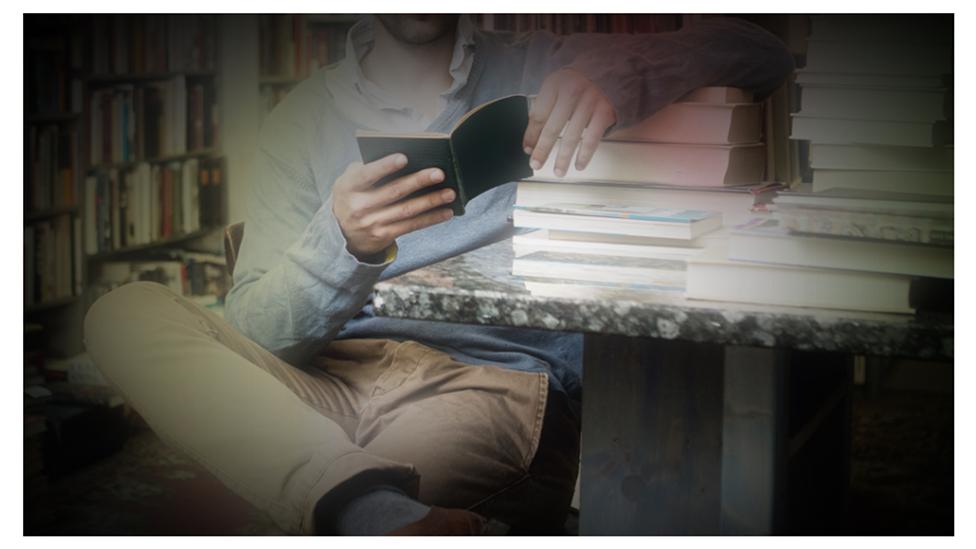 Man looking through books