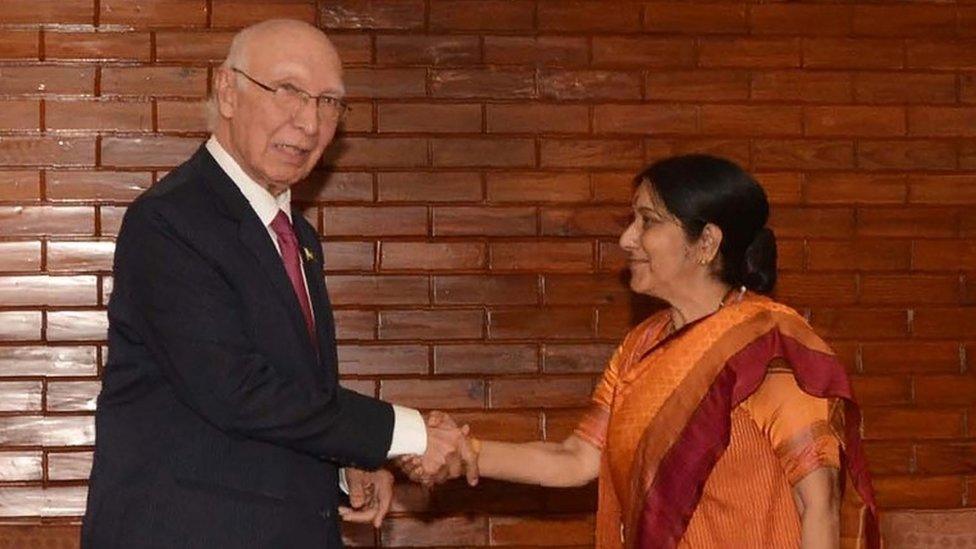 Indian Foreign Minister Sushma Swaraj(R)and Pakistan"s Foreign Affairs Advisor Sartaj Aziz shake hands during a meeting on the sidelines of The South Asian Association for Regional Cooperation(SAARC)foreign minister"s meeting in Pokhara, some 200kms west of Kathmandu on March 17, 2016