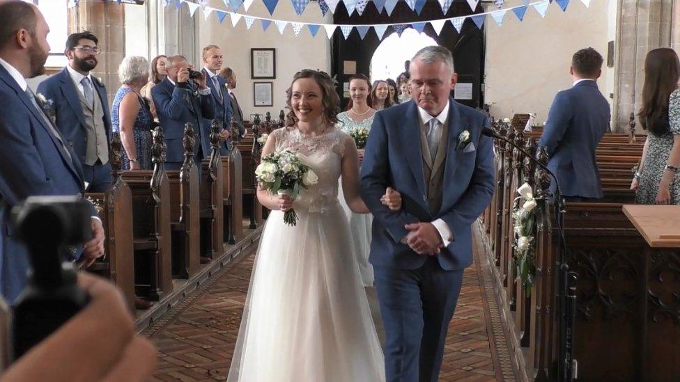 Julia walking down the aisle with her father