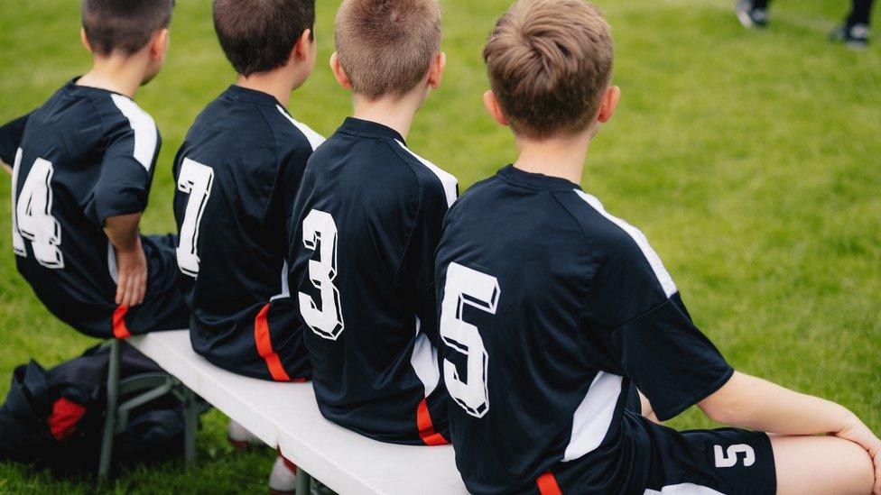 Young boys wearing sports kits