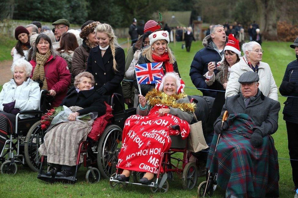 Members of the public wait to see the royals at the Sandringham estate