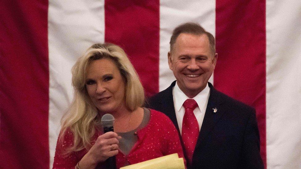 Republican Senatorial candidate Roy Moore smiles as his wife Kayla speaks at a rally in Midland, Alabama, 11 December 2017