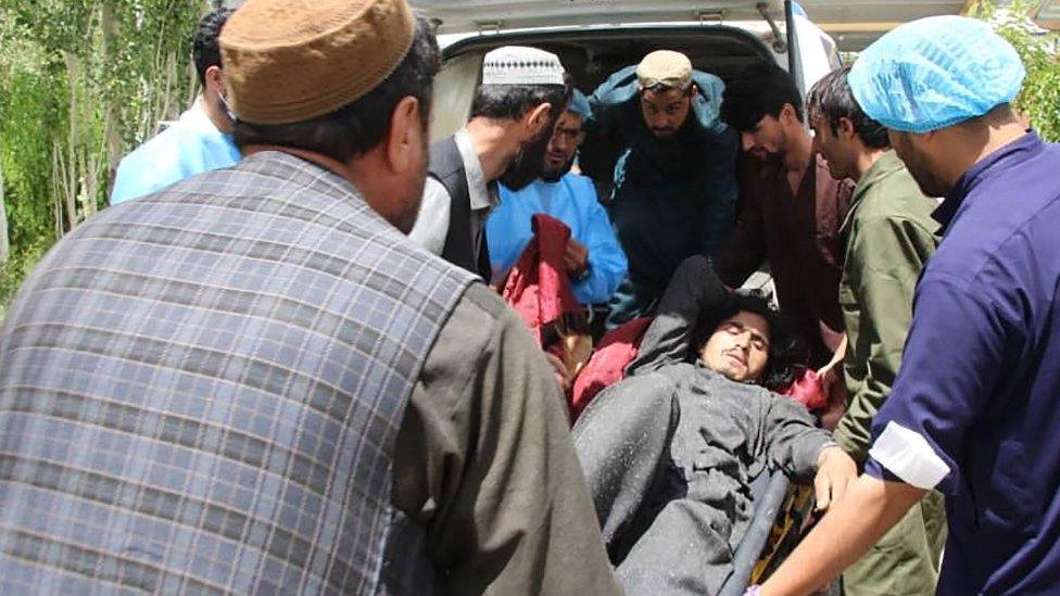 An injured man is loaded on to an ambulance in Afghanistan