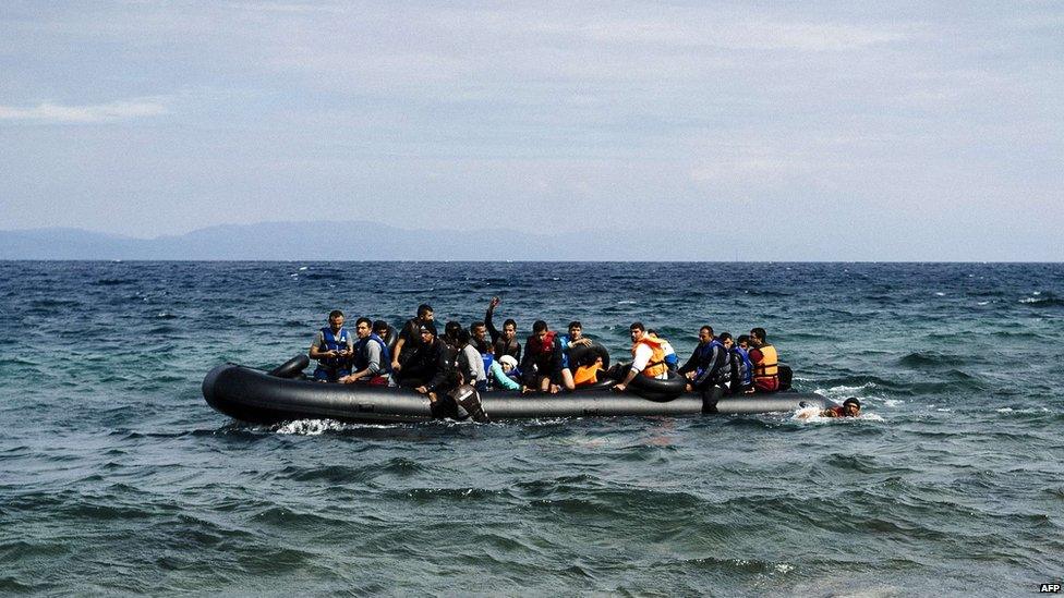 Migrants cross from Turkey to Syria on a boat