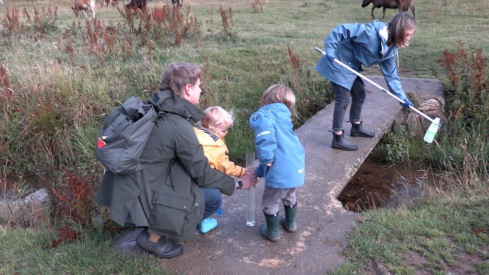 Family taking part in water testing