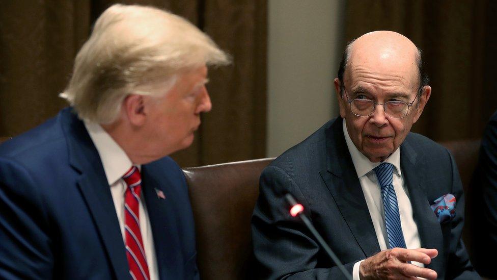 US President Donald Trump (L) listens to Commerce Secretary Wilbur Ross