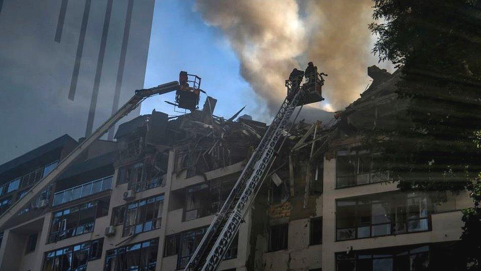 Firefighters at scene of wrecked apartment block in Kyiv, 26 Jun 22