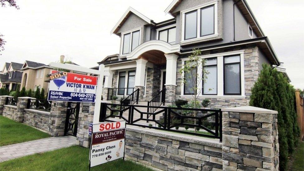 Realtors signs displayed outside a newly sold property in a Vancouver, British Columbia in Canada.