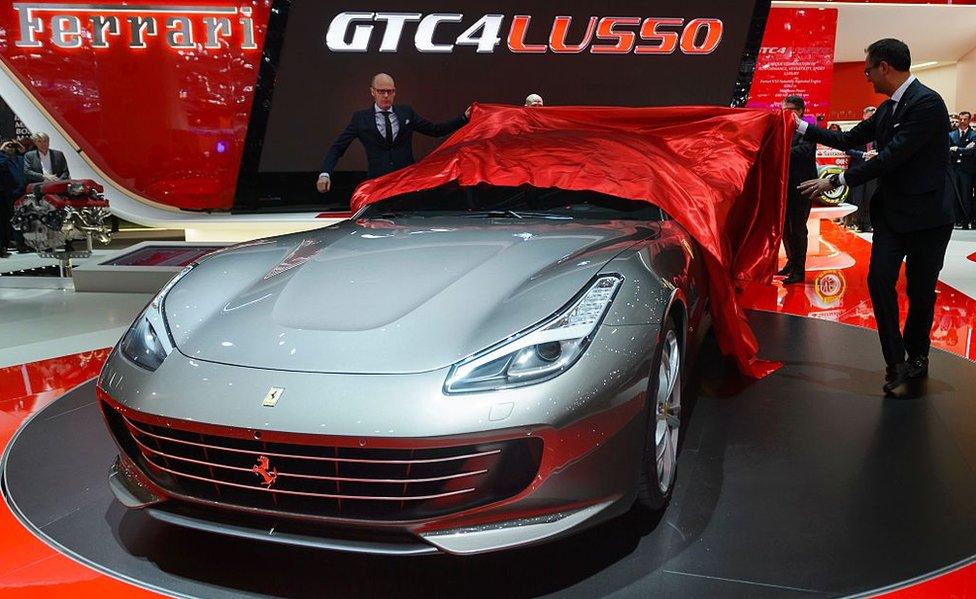 The new Ferrari GTC4 Lusso is unveiled at the stand of Italian carmaker during the press day of the Geneva Motor Show