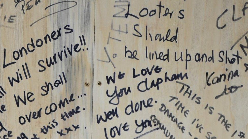 Hopeful and angry messages left on protective hoardings in Clapham after the riots