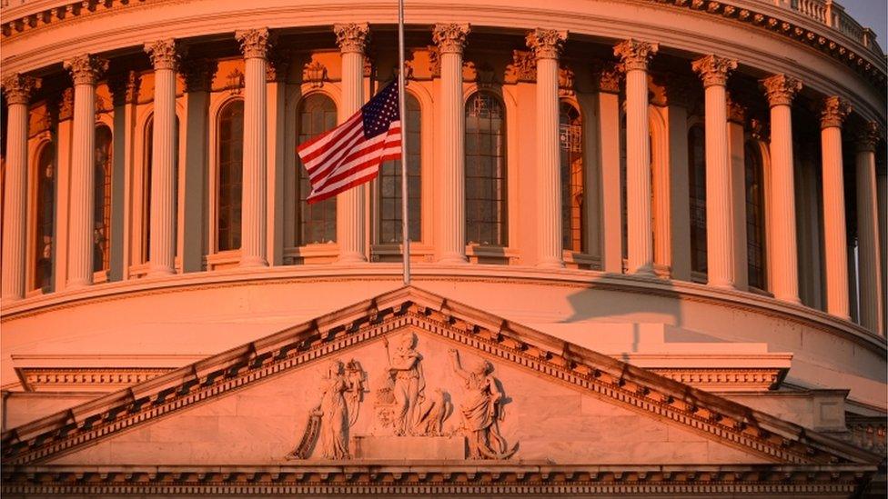 The flag above the U.S. Capitol is at half-staff at sunrise days after supporters of U.S. President Donald Trump stormed the Capitol in Washington