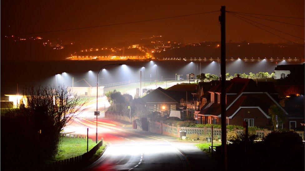 lamp posts at night on an urban street