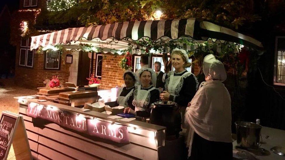 A group of stall workers dressed in Victorian attire at Beaulieu Village Christmas Evening 2018