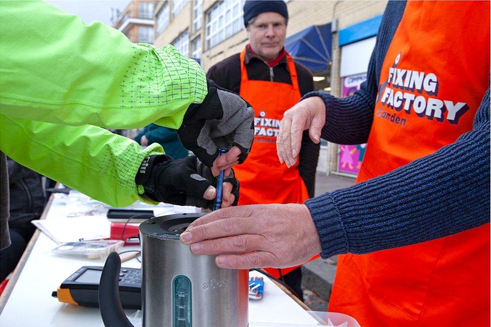 Volunteers repair electrical items at the Fixing Factory in Camden, London