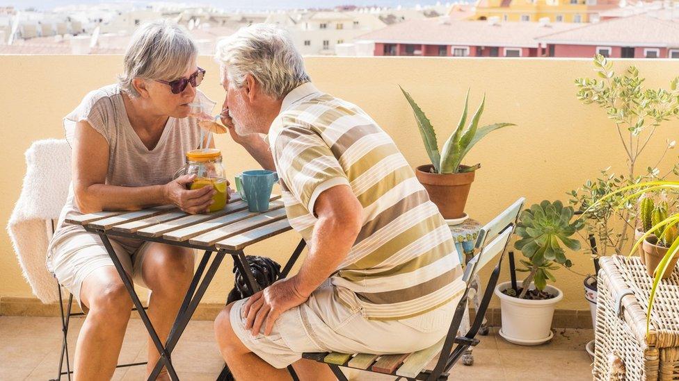 Pensioners drinking on a balcony