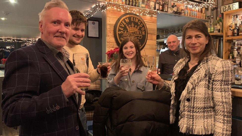 Mark Ellison (second from right) and customers celebrate the end of the Manx lockdown