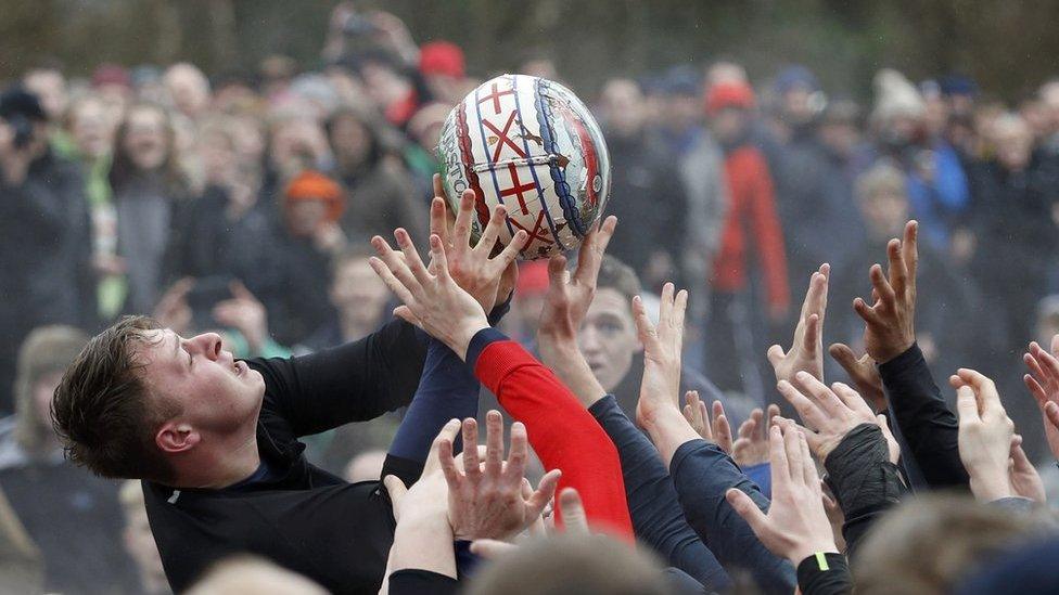 Players compete for the ball during the annual Shrovetide football match in Ashbourne, 28 February 2017