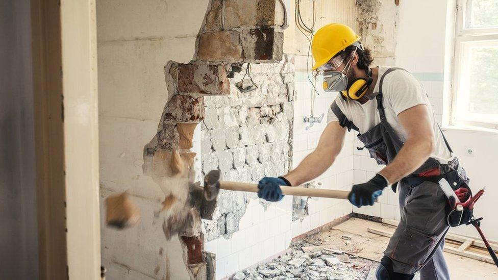 Worker using hammer, home renovation