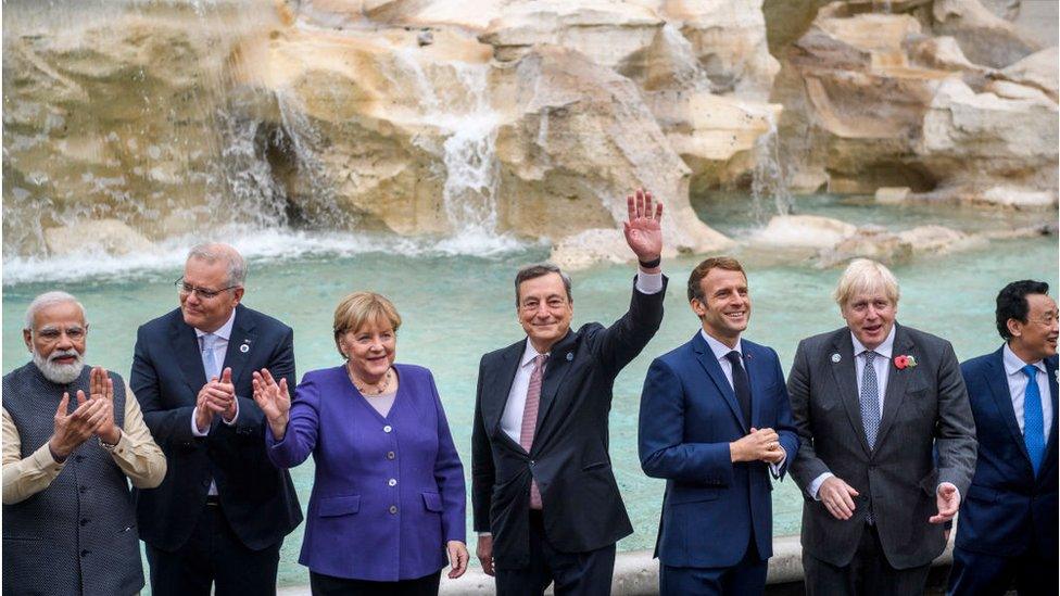 World leaders wave to the cameras in front of the Trevi fountain