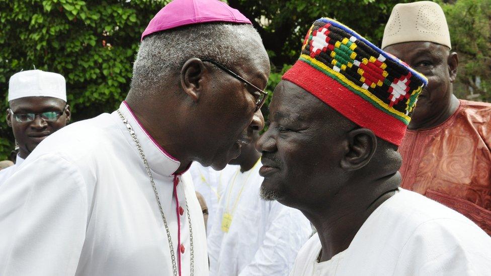 Archbishop of Ouagadougou Philippe Ouedrago (L) wishes a good Eid to Burkinabe chief the Mogho Naba Baongo in Burkina Faso, 2012