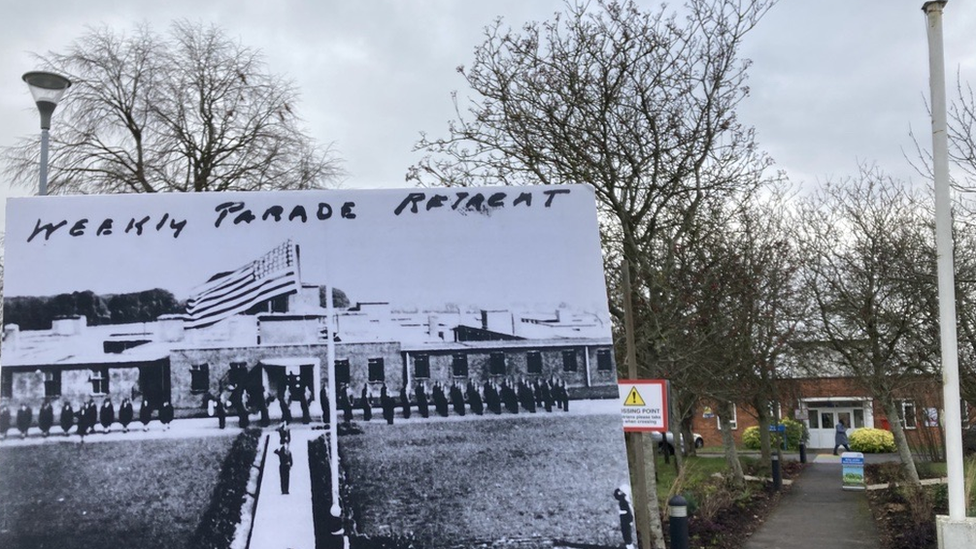 A black and white picture of a military parade in front of the main building being held in front of the same place today