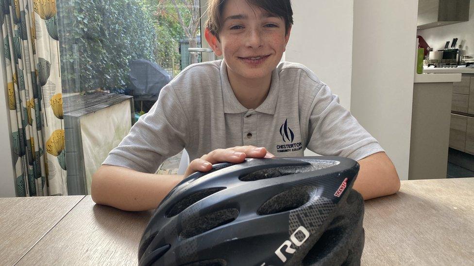 Boy with his bike helmet