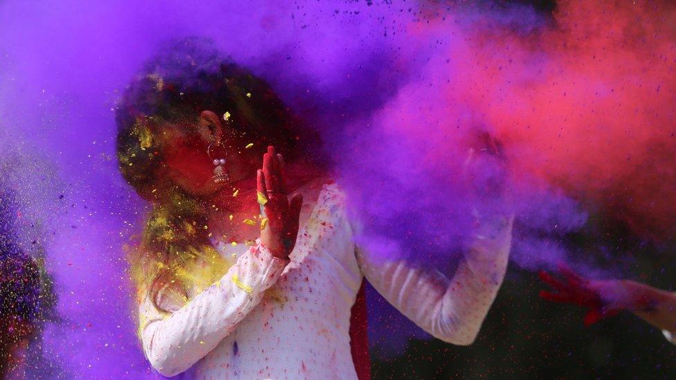 Colour being thrown on a woman