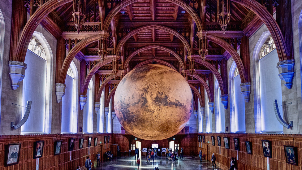 Mars underneath a wooden ceiling