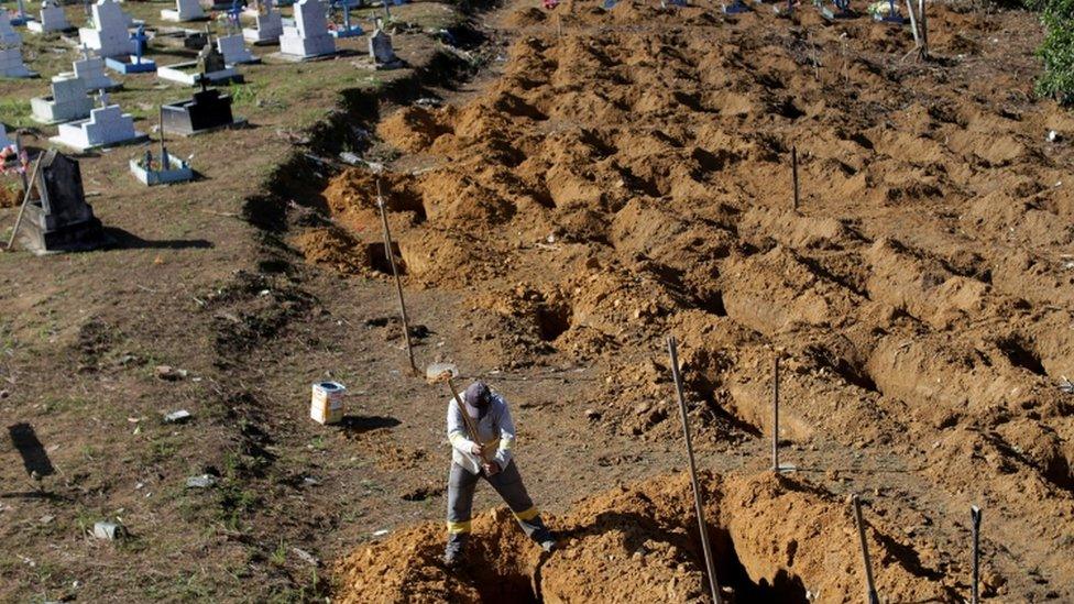 A worker prepares graves for victims of the Manaus prison riot, 4 Jan 2017