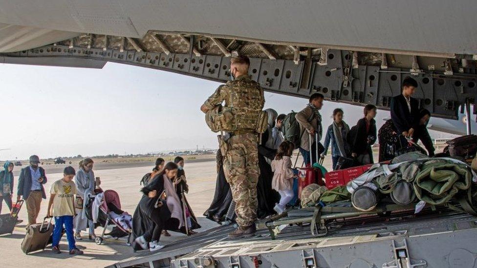 Afghans board a UK C-17 aircraft