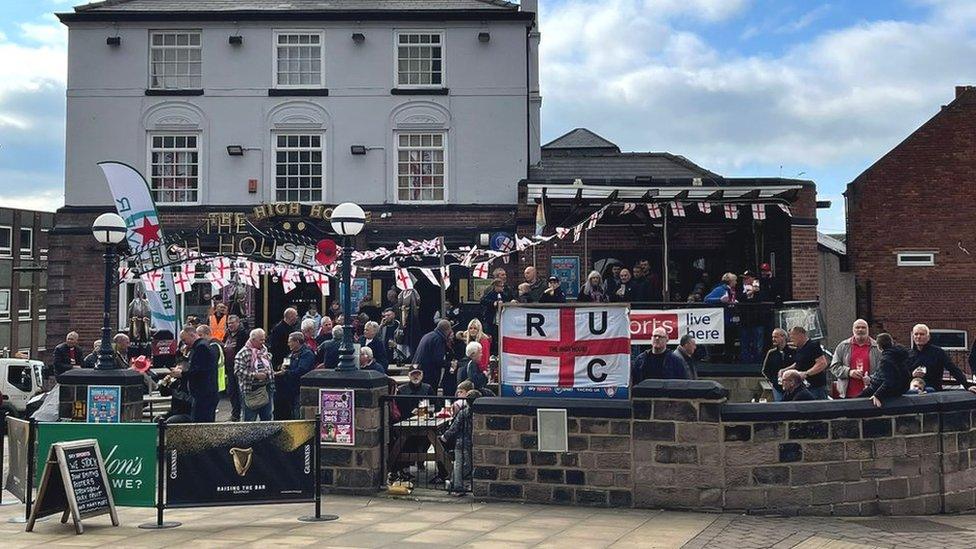 A nearby pub with flags