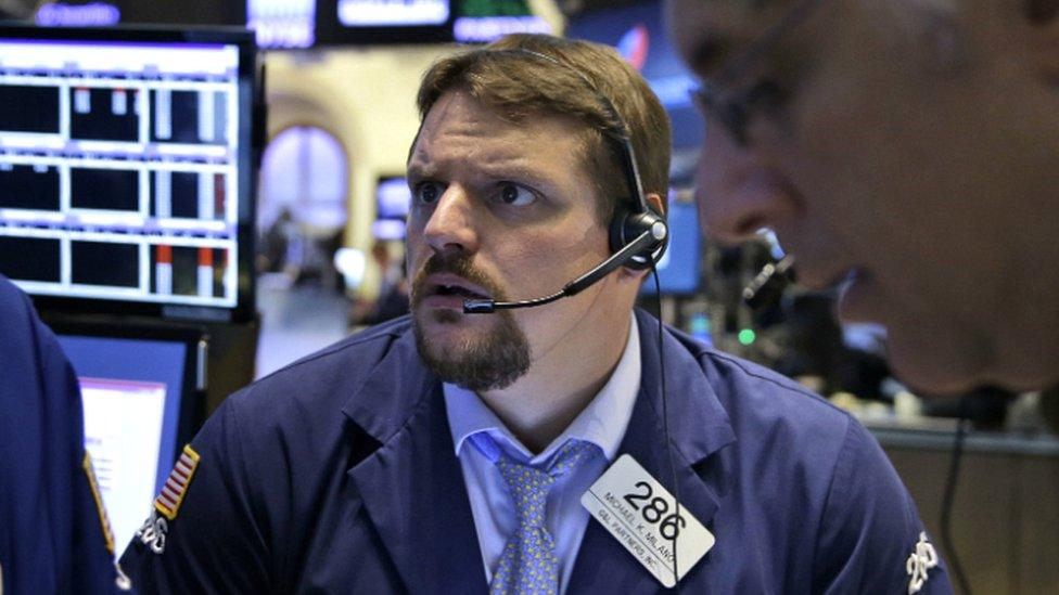 Traders work on the floor at the New York Stock Exchange in New York - 8 July 2015