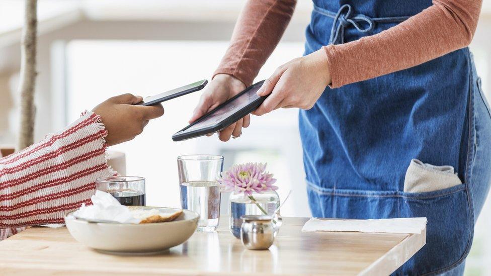 Waitress scanning customers' phone