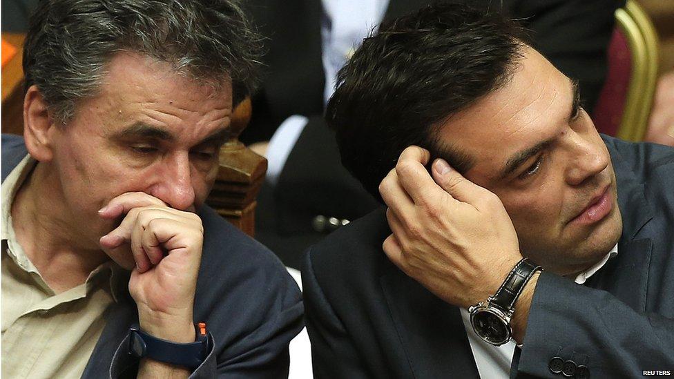 Greek Prime Minister Alexis Tsipras (L) sits next to Finance Minister Euclid Tsakalotos (R) on 15 July