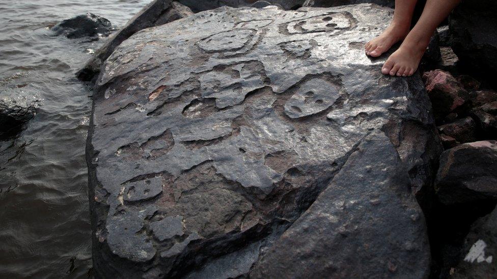 Amazon riverbank ancient stone carvings