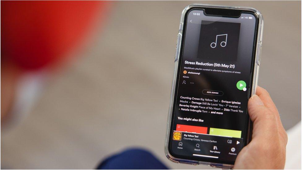 A photo of a phone showing a playlist