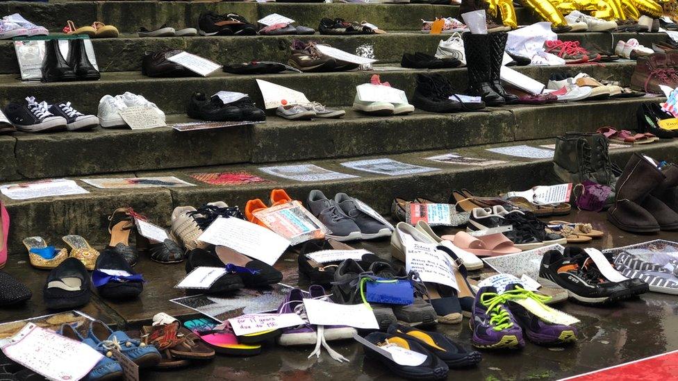 Protestors have laid out shoes in London in honour of loved ones who are too fatigued to be there