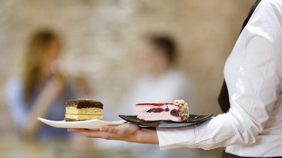 Waitress holding desserts