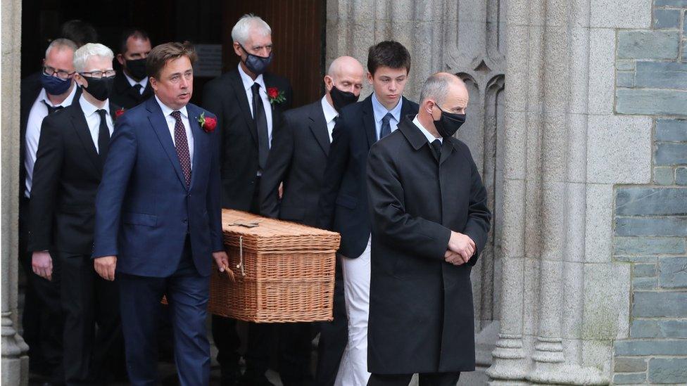 The casket of the former SDLP leader is carried by his son, John Hume Junior, and other family members.