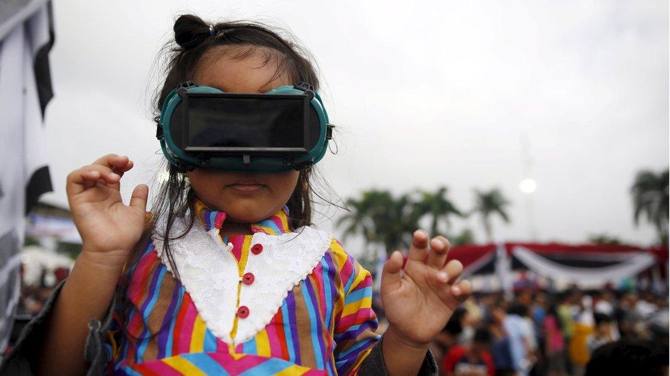 A child with special goggles on, in Indonesia