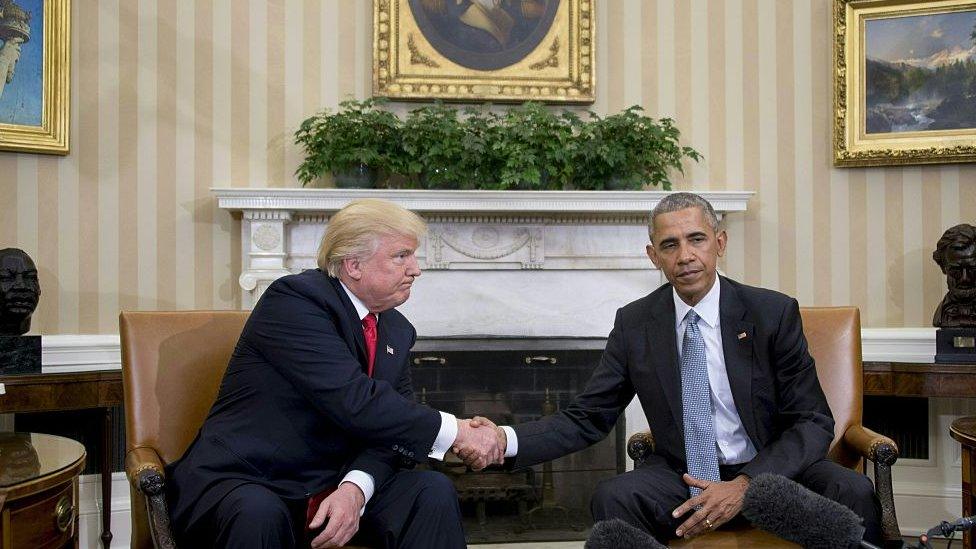 Donald Trump and Barack Obama shake hands in the Oval Office.