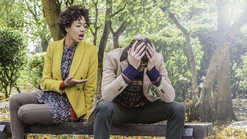 Couple arguing in park (posed by models)