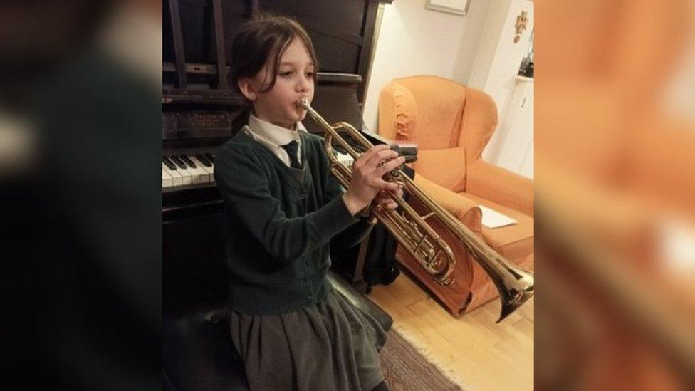 Rebekah playing the trumpet