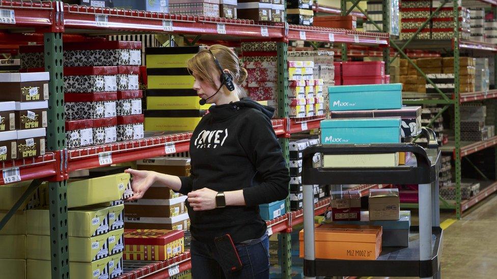 A warehouse employee using a voice-directed application headset featuring the Jennifer voice