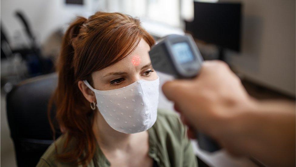 Worker getting temperature checked