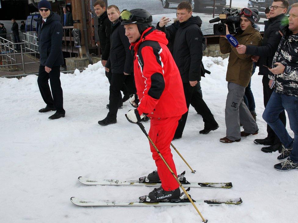 President Putin on skis wearing a red suit