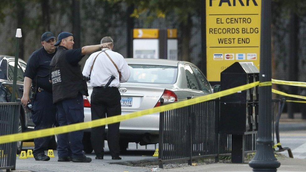 Crime scene investigators survey area after a shooting in Dallas, Friday, July 8, 2016