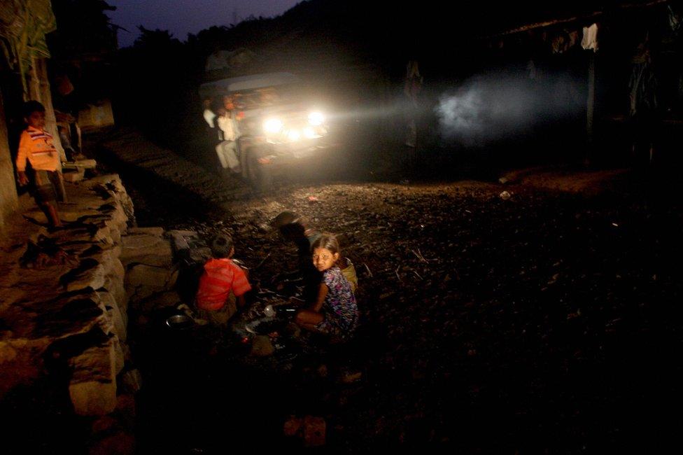 Indian children play outside their home in the tribal hamlet of Wada, in Thane on the outskirts of Mumbai on November 18 2007.